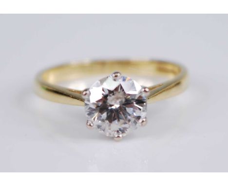 An 18ct yellow and white gold diamond solitaire ring, featuring a round brilliant cut diamond in a six-claw setting, diamond 