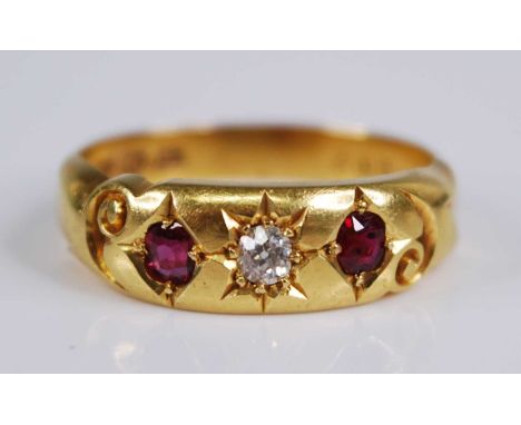 An Edwardian 18ct gold, ruby and diamond ring, the 'gypsy' set old round cut diamond weighing approx 0.1 carats, flanked to e