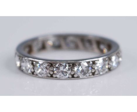 A white metal diamond full hoop eternity ring, grain set with 16 round brilliant cut diamonds, dimensions each approx 3.2 x 1