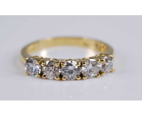 An 18ct yellow gold diamond five stone half hoop eternity ring, featuring five round brilliant cut diamonds in claw settings,