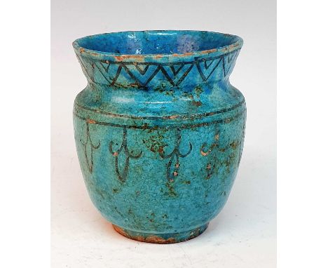 A Persian Kashan turquoise glazed earthenware jar, probably medieval, decorated with chevron and spearhead borders, h.15cm
