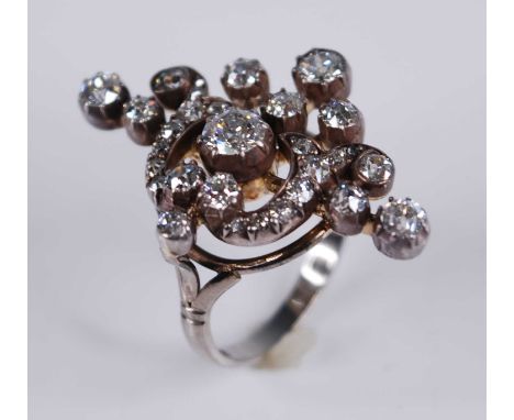 A white metal diamond openwork navette shaped cluster ring, comprising 30 Old European and rose cut diamonds in cut-down grai