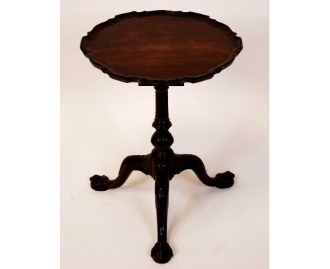 A 19th century mahogany pedestal tripod low occasional table, in the manner of Thomas Chippendale, having a piecrust top with