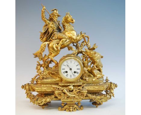 A late 19th century French gilt brass mantel clock, of good size, the white enamel Roman dial surmounted with a huntsman upon