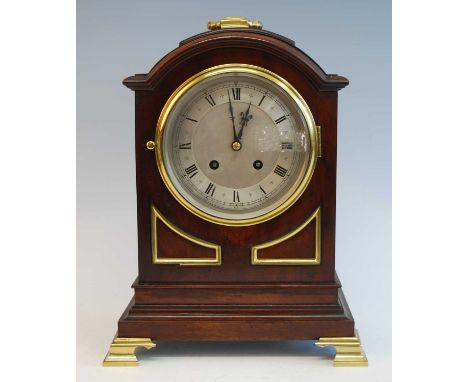 An early 20th century mahogany and brass mounted bracket clock in the Georgian style, having an unsigned silvered Roman dial 