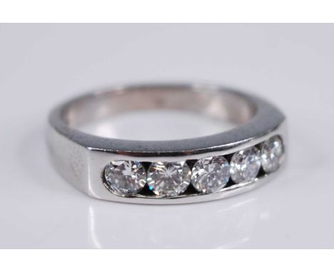 A contemporary 18ct white gold diamond half hoop ring, the five channel set brilliants each weighing approx 0.2 carats, colou