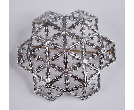 A modern 18ct white gold and diamond set snowflake brooch, of openwork convex form, centre set with a raised brilliant weighi