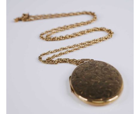 A 9ct yellow gold oval locket, engraved with foliate detail, locket dimensions 42 x 32mm, attached to a Prince of Wales rope 