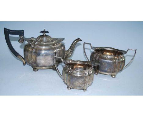 A George V three-piece silver tea set, comprising teapot, twin handled sugar and cream, each piece of gadrooned and shaped ov