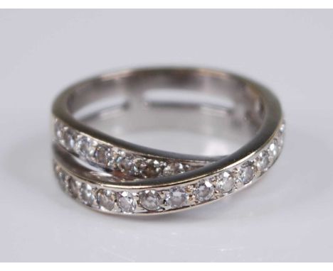 A contemporary white metal and diamond double half hoop ring, arranged as two overlapping bands each pavé set with seventeen 