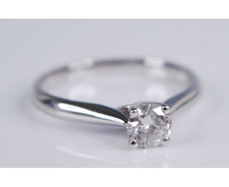 A contemporary 18ct white gold diamond solitaire ring, the four-claw set brilliant weighing approx 0.5 carats, 3.8g, size R+