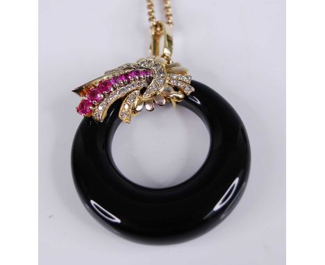 A yellow metal onyx, ruby and diamond pendant, featuring an onyx band surmounted by a cornucopia claw set with seven graduate