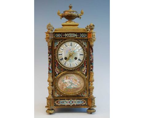 An early 20th century French ormolu and champleve enamel mantel clock, the convex white enamel Roman dial signed by the retai