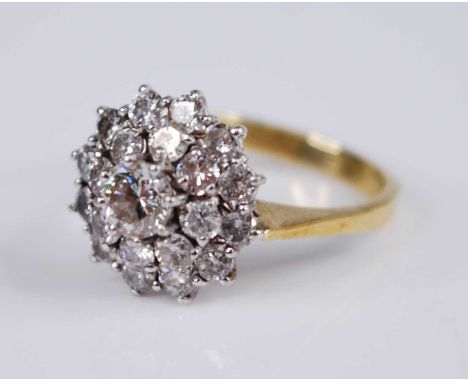 A yellow and white metal diamond circular cluster ring, featuring a centre round brilliant cut diamond within borders of eigh