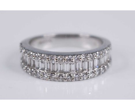 A contemporary platinum and diamond set half hoop ring by Pravens, the tapering band centre set with 24 graduated baguettes f