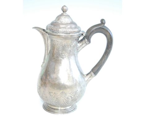 A George II silver hot water pot, of baluster form and repousse decorated with shells and foliate scrolls, having hinged lid 