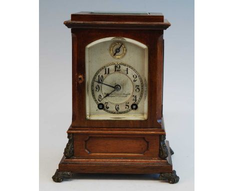 An Edwardian walnut cased four glass bracket clock by Winterhalder &amp; Hoffmeier, signed to the silvered arched dial  by th