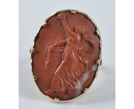 A yellow metal oval lava stone cameo ring, depicting a female figure in classical dress, with trifurcated shoulders, cameo di