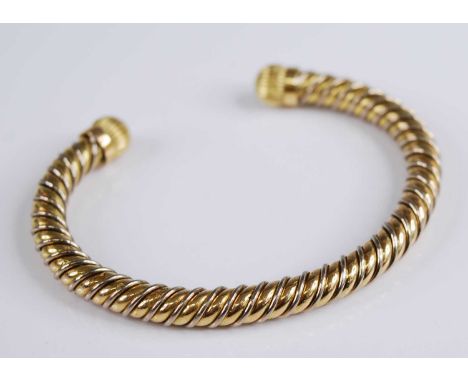 An 18ct yellow gold and white metal bound cuff bangle, of spiral reeded form, sponsor AC, London 1994, 53g