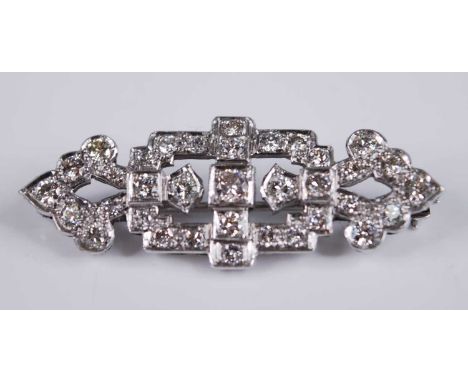 A white metal Art Deco diamond panel brooch, featuring 35 transitional brilliant cut diamonds in grain settings, with a rolle
