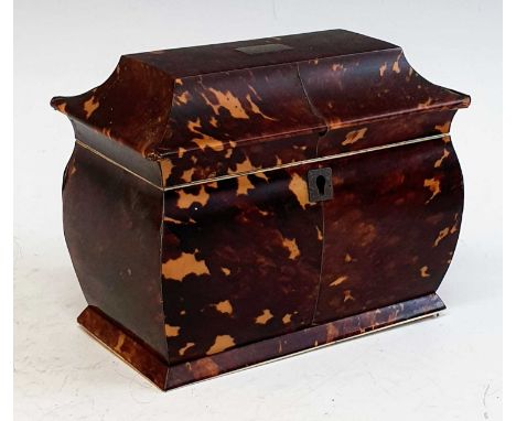 A 19th century tortoiseshell and ivory tea caddy, the cavetto moulded lid having vacant cartouche lifting to reveal twin comp