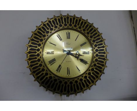 A brass circular wall clock 