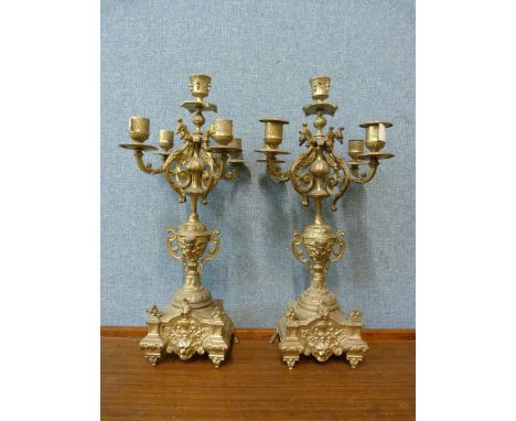 A pair of white metal candelabra 