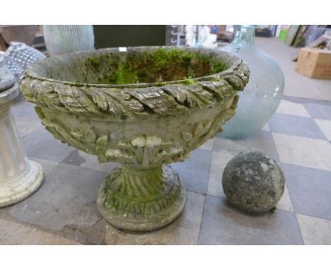 A concrete garden urn and stone ball 