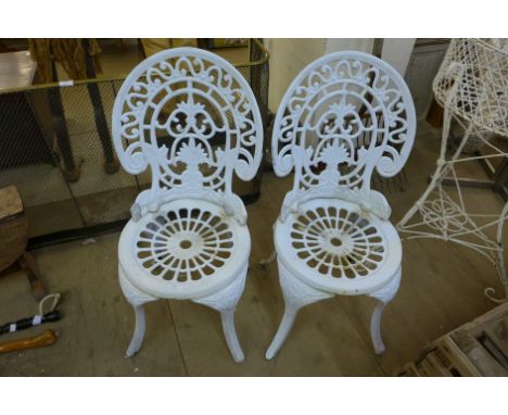 A pair of Victorian style painted cast iron garden chairs 