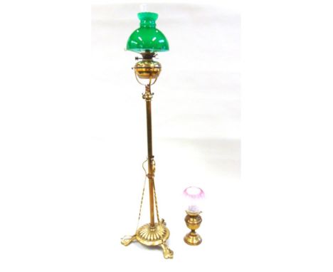 AN EDWARDIAN OIL LAMP ON TELESCOPIC BRASS STAND,  with green glass shade, and a further oil lamp converted to electricity wit