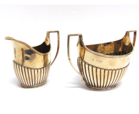 A LATE VICTORIAN SILVER CREAM JUG AND SUGAR BASIN by Charles Stuart Harris, London 1892, of oval outline, gadrooned decoratio