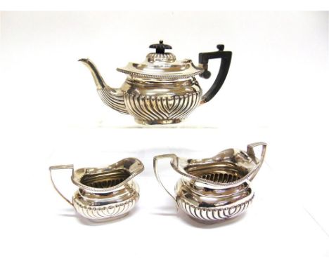 A THREE PIECE BACHELOR TEA SERVICE by Henry Bourne, Birmingham 1903, of rounded rectangular gadrooned form, 610g (19.6 troy o