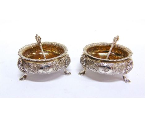 A PAIR OF VICTORIAN SILVER SALTS by Martin & Hall, London 1876, of circular cauldron form embossed with flowers, gadrooned ri