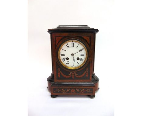 AN EDWARDIAN MANTLE CLOCK  with French 8-day movement, in walnut case with marquetry decoration, the 4' enamel dial with Roma
