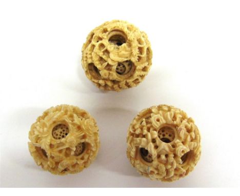 THREE LATE 19TH CENTURY CHINESE IVORY PUZZLE BALLS the first with six concentric inner spheres, overall 4.75cm diameter (inte