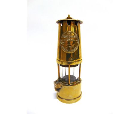 A BRASS MINER'S LAMP, 'THE PROTECTOR' by the Lamp & Lighting Co. Ltd of Eccles, Manchester, with applied embossed brass maker