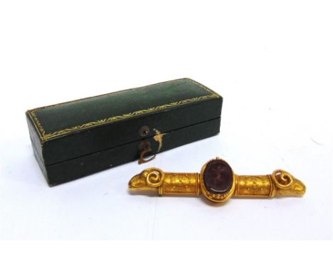 AN ARCHEALOGICAL REVIVAL BROOCH circa 1870, with a carved cornelian scarab beetle rotating with a putto carrying a trident to