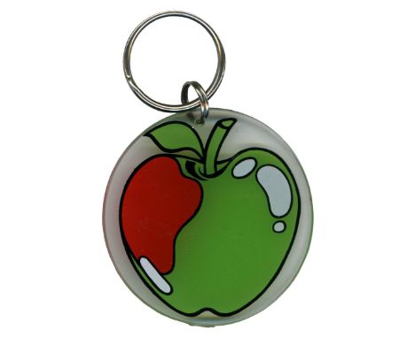 An original 1970s Apple Records key ring bearing a green and red apple image printed on clear Perspex. The key ring comes wit
