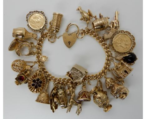 A large and extensive 9ct gold charm bracelet, to include an 1899 gold full sovereign, a 1907 gold half sovereign and twenty 