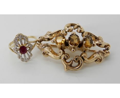 A bright yellow metal Victorian brooch set with citrines and a 10k gold ring set with diamonds and a red gem size M, weight f