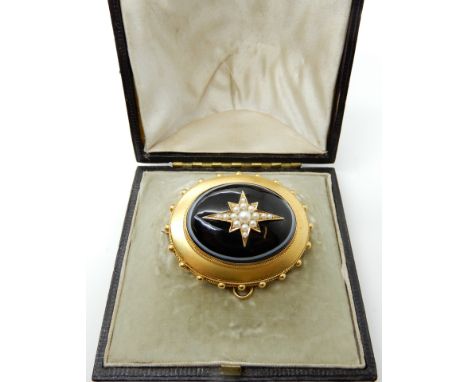 A yellow metal bullseye agate mourning brooch with locket back and pearl set star to front, 4cm x 3.2cm, weight 20.4gms Condi