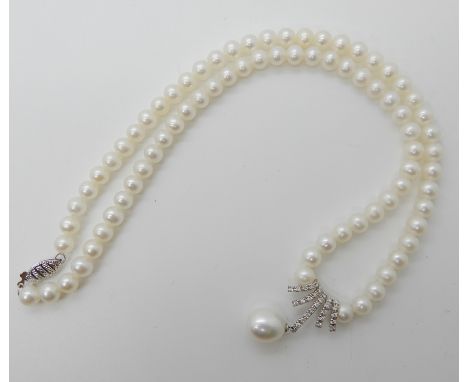 A string of cultured pearls with a 9ct diamond set pendant with pearl drop, 43.5cm long, weight 20.5gms Condition Report: Ava
