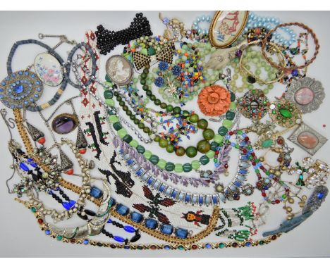 A bag of vintage costume jewellery to include an unusual Native American bead work necklace, featuring whales, eagles and shi