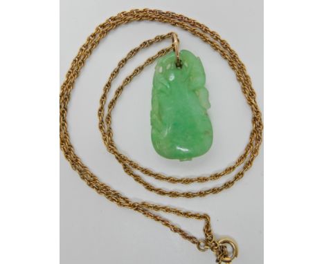A Chinese green hardstone pendant carved with a bird and aubergine, dimensions 3.2cm x 1.8cm, on a gold plated chain, weight 