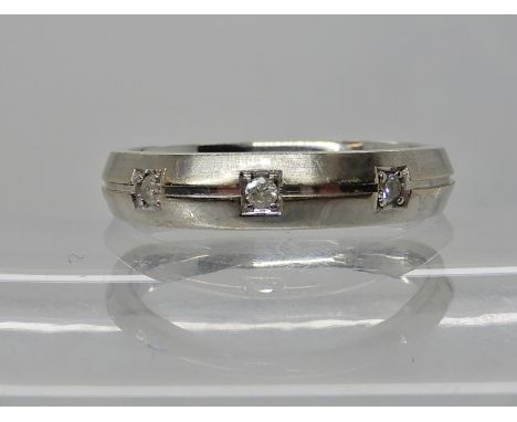 A 9ct gold three stone diamond set wedding ring size O, weight 3.7gms Condition Report: Available upon request