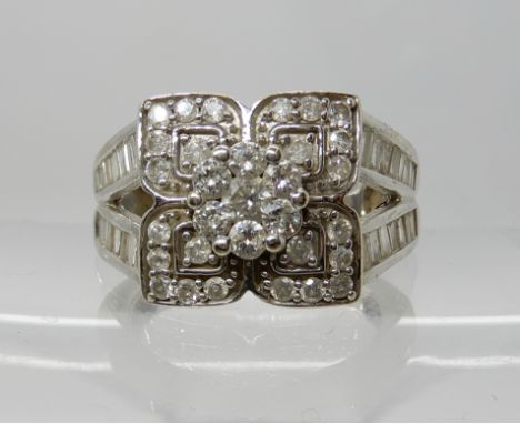 A 9ct white gold diamond fancy cluster ring set with estimated approx 0.85cts of baguette and brilliant cut diamonds, size N1