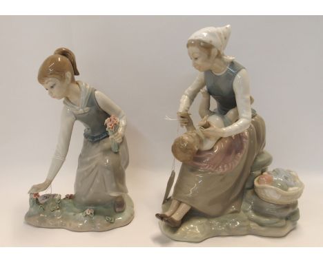 A Lladro figure of a girl picking flowers and a Nao figure of a mother and baby Condition Report: Available upon request