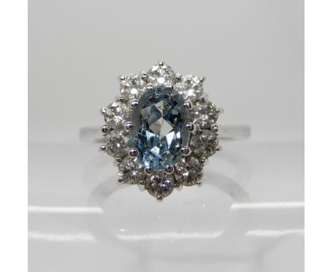 An 18ct white gold aquamarine and diamond ring, diamonds estimated approx at 0.60cts, aquamarine approx 6.8mm x 4.6mm, finger