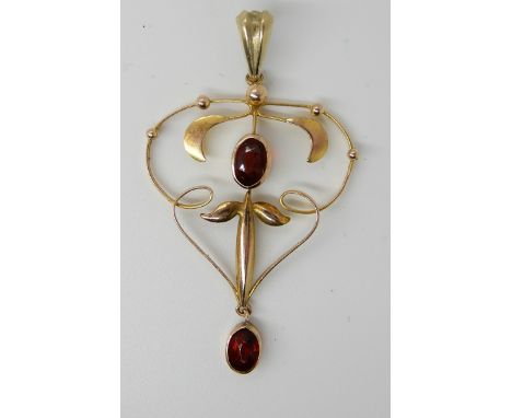 A 9ct gold Edwardian pendant set with red gems, dimensions 4.5cm x 2.6cm, weight 1.7gms Condition Report: Available upon requ