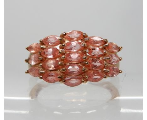 A 9ct rose gold padparadscha sapphire cluster ring, finger size P, weight 3.9gms, with a Rocks &amp; Co certificate Condition